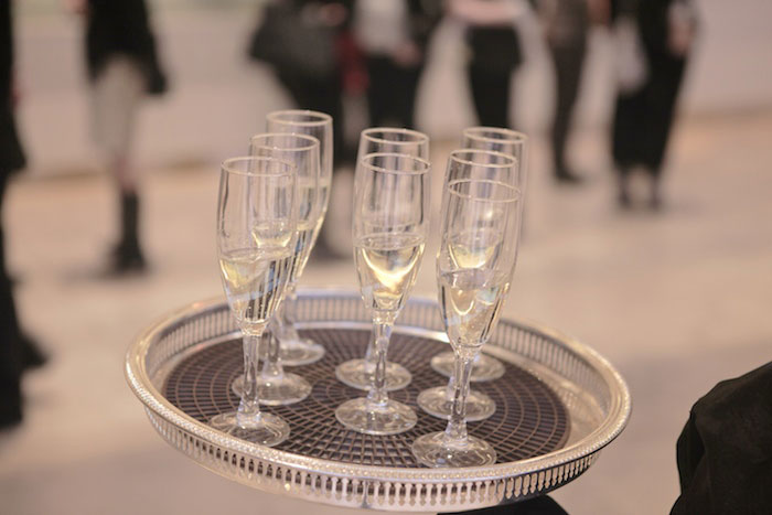 Glasses of Champagne on a serving tray at a cocktail party by lifestyle photographer Kevin Charlie Glasses of Champagne on a serving tray at a cocktail party by lifestyle photographer Kevin Charlie